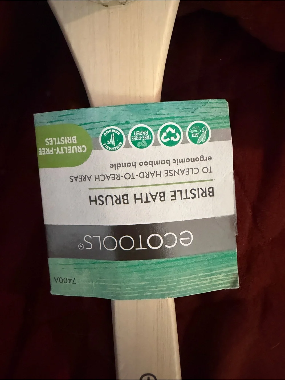 ecotools Bamboo Long Handle Body Brush with Teal Loop on Rust Background